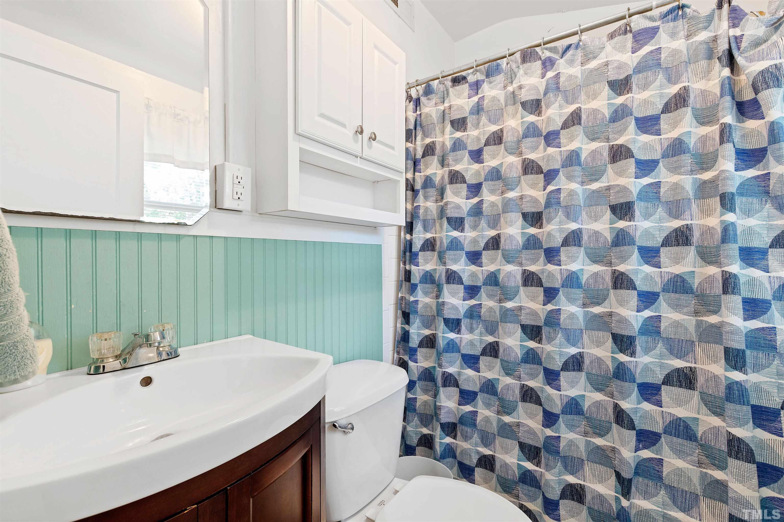 110 Shepherd Street Raleigh, NC 27607 - Photo 32 of 41 a bathroom with a sink a toilet and a mirror