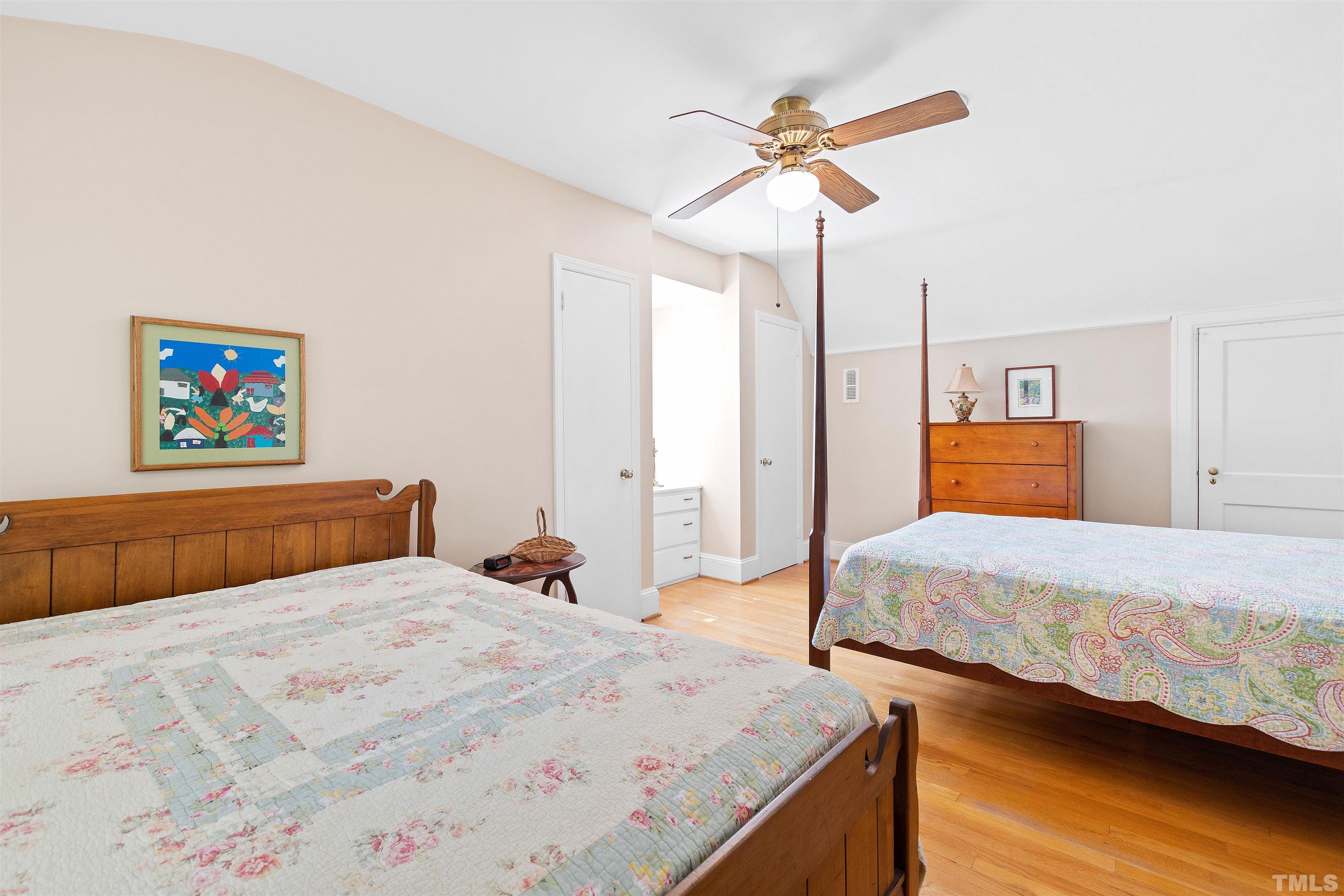 110 Shepherd Street Raleigh, NC 27607 - Photo 34 of 41 a bedroom with a bed and a chandelier