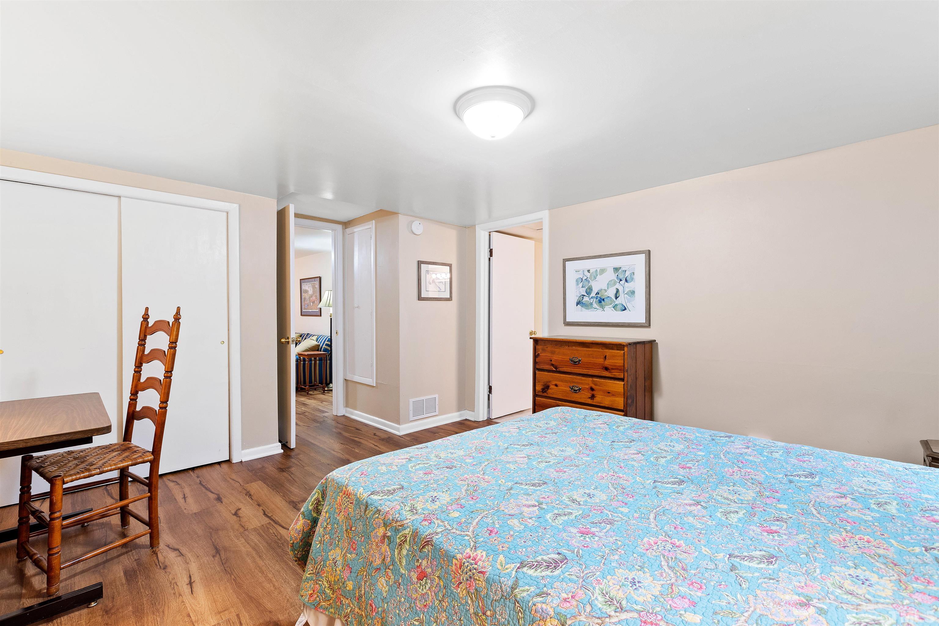 110 Shepherd Street Raleigh, NC 27607 - Photo 38 of 41 a bedroom with a bed and dresser with wooden floor