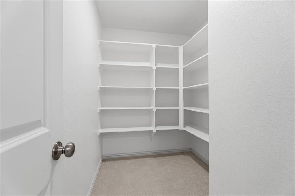 1316 Limestone Ridge Road Mansfield, TX 76063 - Photo 13 of 40 Built-in shelving spanning multiple walls, offering extensive storage