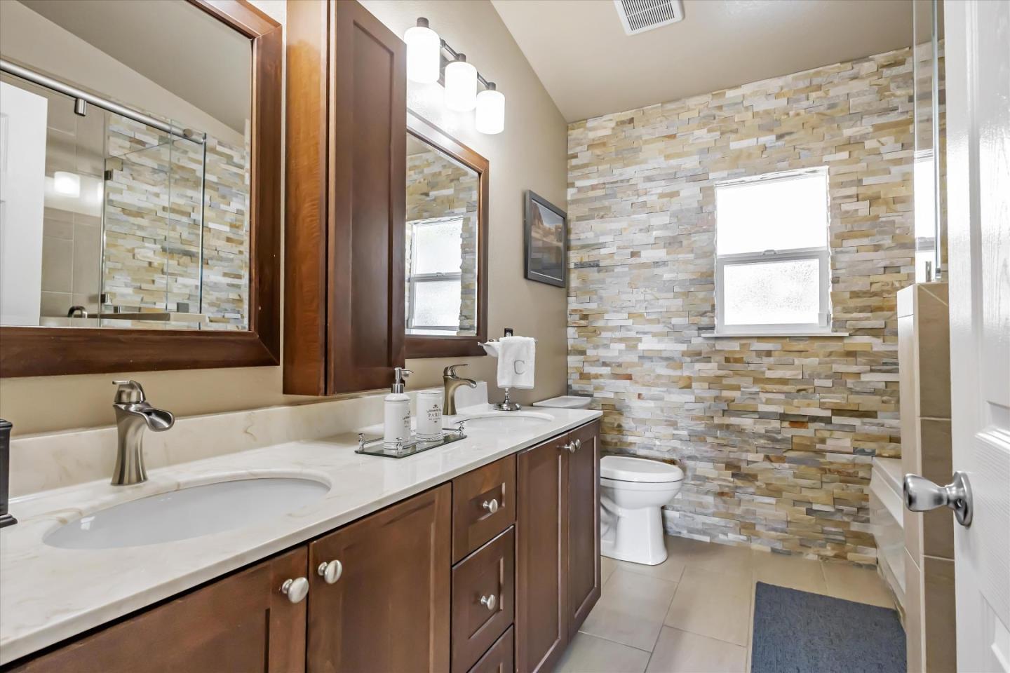 327 Farallon Avenue Pacifica, CA 94044 - Photo 35 of 74 a bathroom with a double vanity sink toilet and a mirror