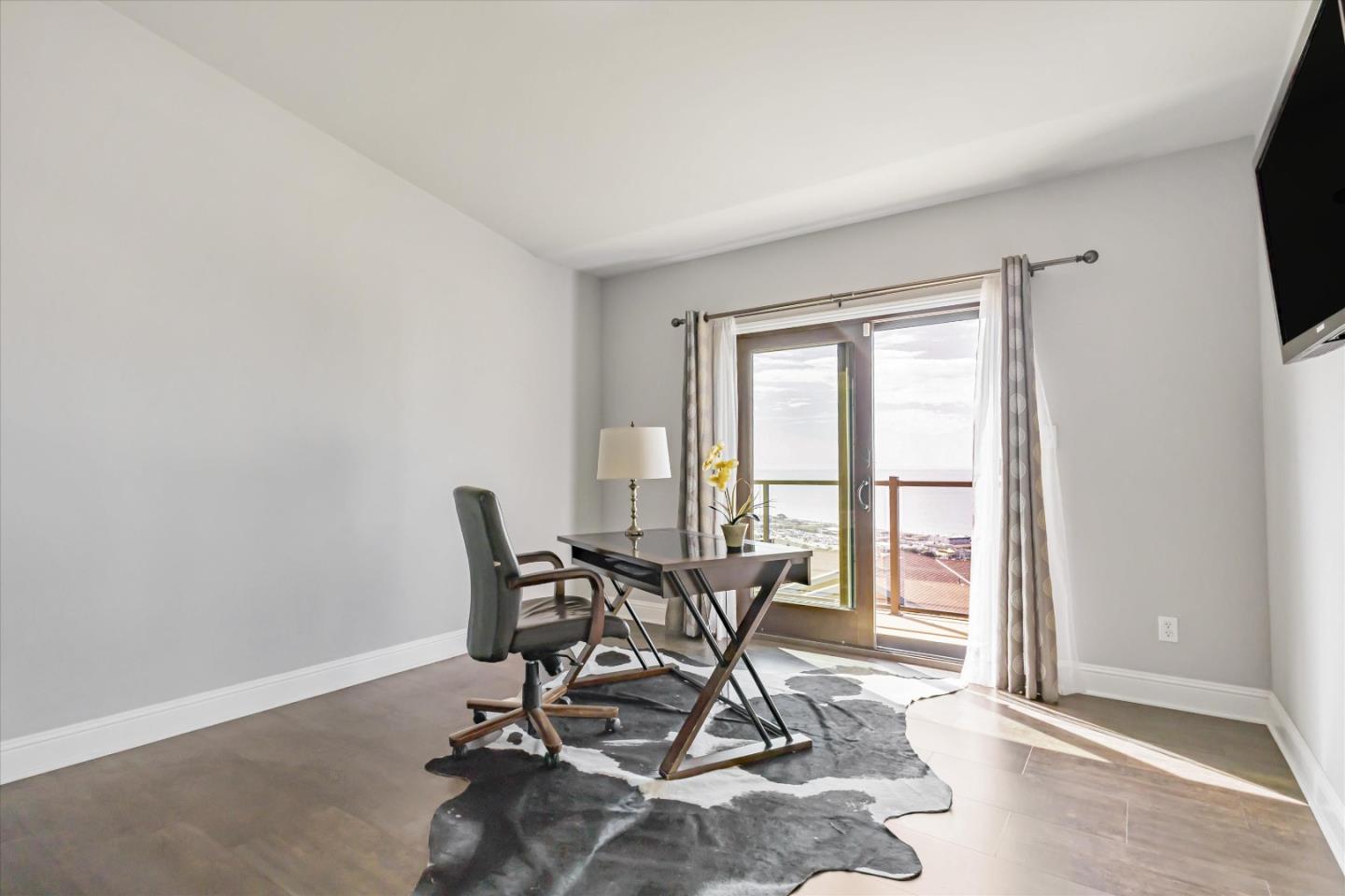 327 Farallon Avenue Pacifica, CA 94044 - Photo 41 of 74 a workspace filed with furniture and a flat screen tv