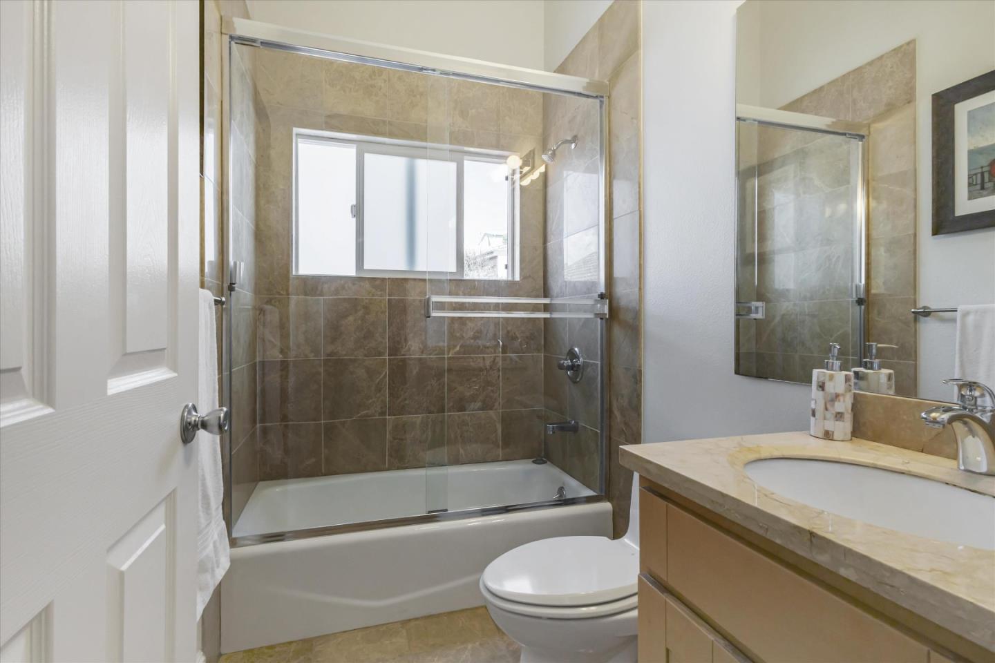 327 Farallon Avenue Pacifica, CA 94044 - Photo 45 of 74 a bathroom with a granite countertop toilet a sink and a bathtub