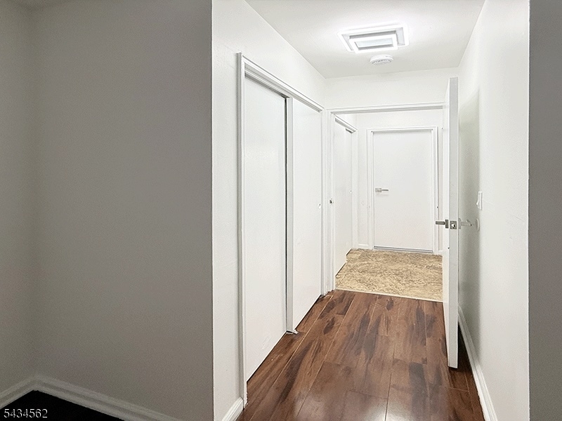 19 Van Rensselear Street, Unit 2 Belleville, NJ 07109 - Photo 7 of 7 a view of a hallway with wooden floor and staircase