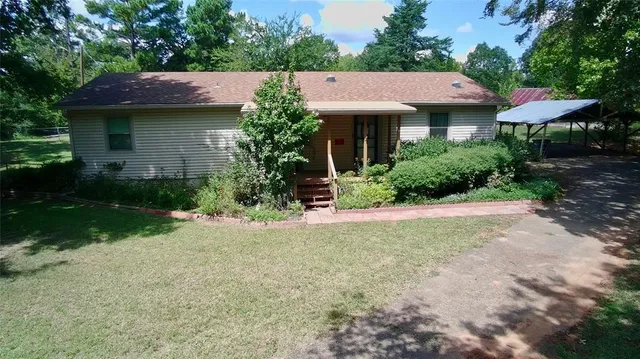 a aerial view of a house with yard and plants