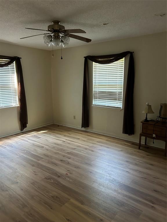 4546 Farm To Market 515 Quitman, TX 75783 - Photo 11 of 17 a view of an empty room with a window and wooden floor