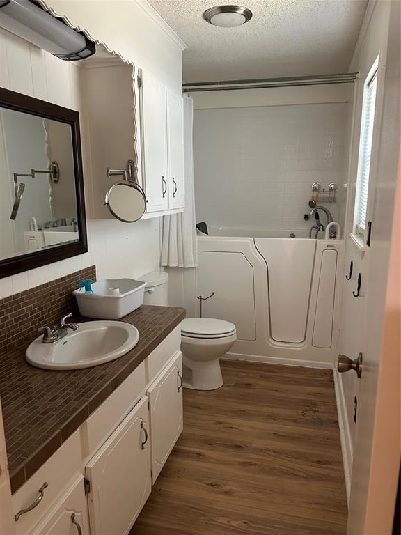 4546 Farm To Market 515 Quitman, TX 75783 - Photo 12 of 17 a bathroom with a granite countertop sink toilet and mirror