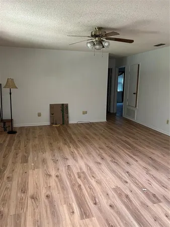 a view of a room with wooden floor