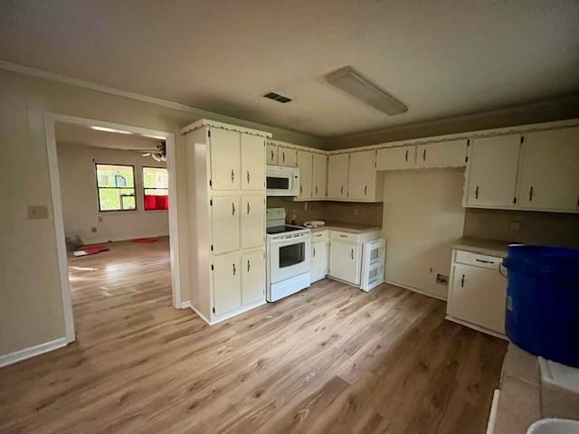 4546 Farm To Market 515 Quitman, TX 75783 - Photo 8 of 17 a kitchen with granite countertop a refrigerator oven a sink dishwasher and white cabinets with wooden floor
