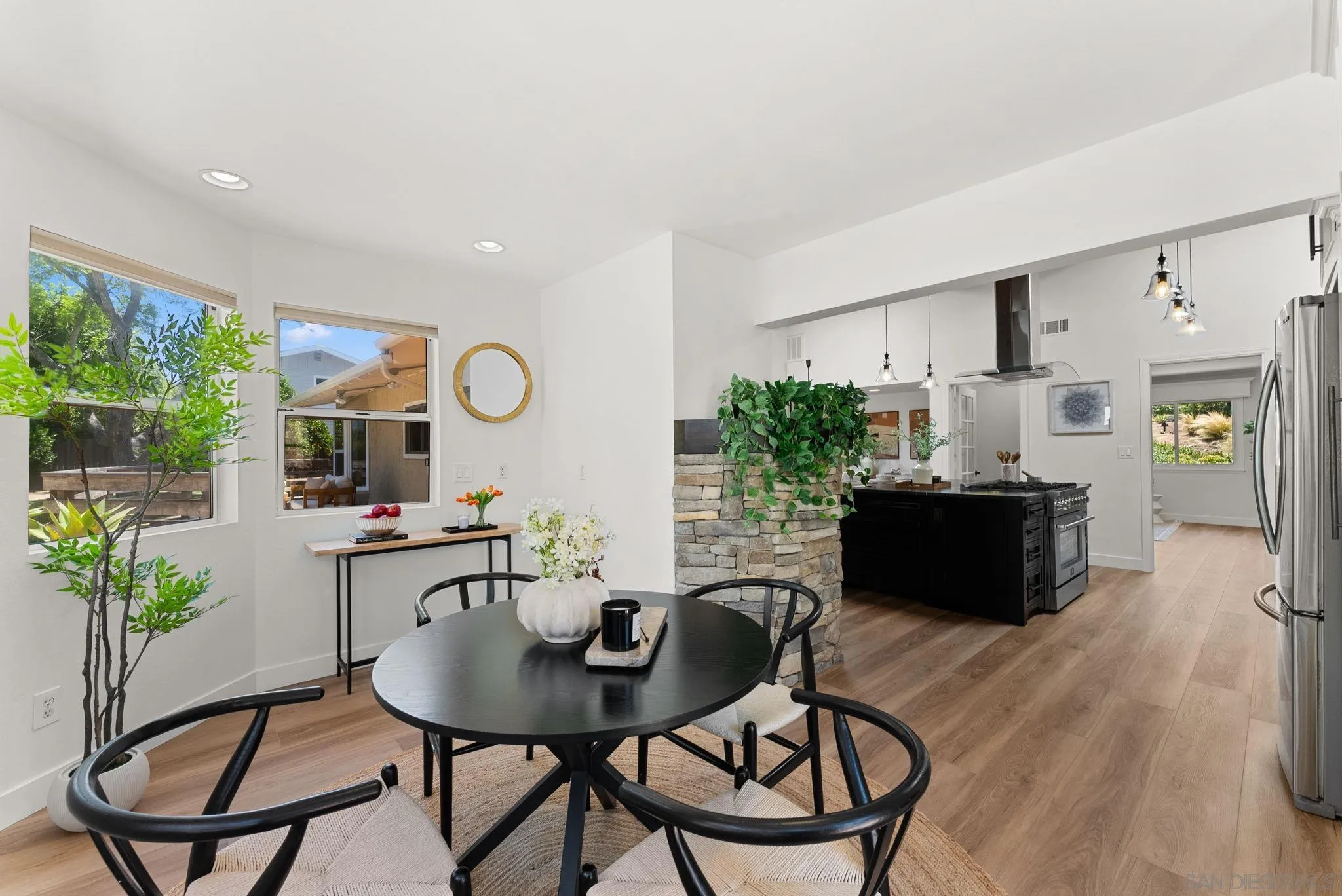 12832 Stone Canyon Road Poway, CA 92064 - Photo 11 of 60 a view of a dining room with furniture and a potted plant