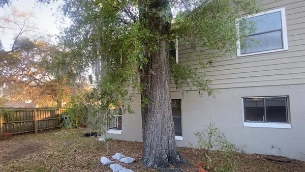 an empty room with closet and windows