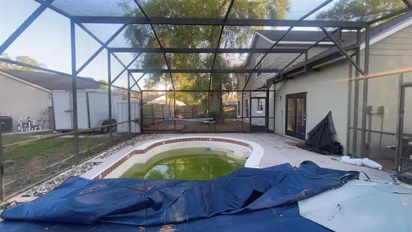 a view of a swimming pool with a yard