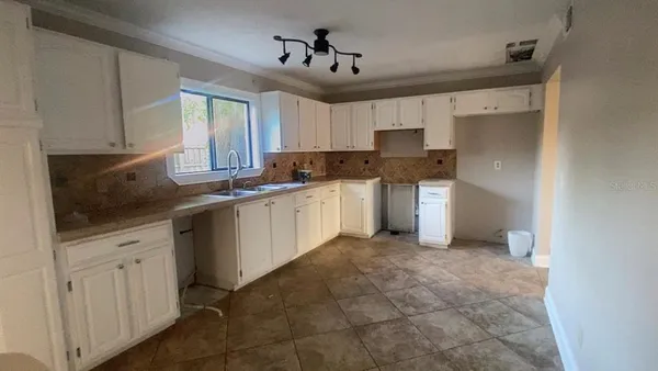 a kitchen with a sink stove and cabinets