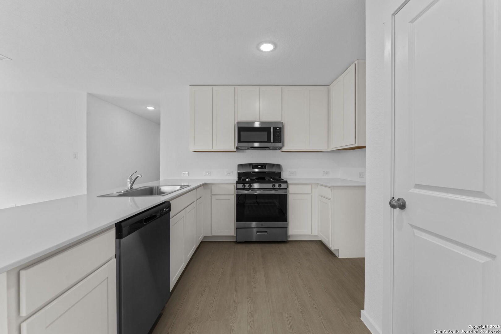 1835 Nuthatch Ridge New Braunfels, TX 78130 - Photo 15 of 23 a kitchen with a sink and a stove top oven