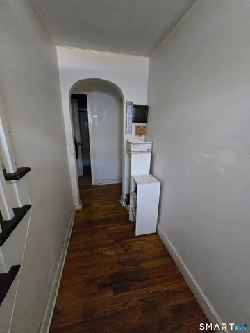 a view of entryway and hall with wooden floor