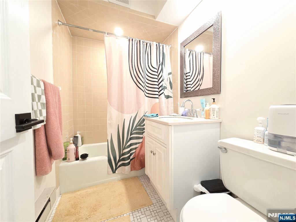 150 County Road, Unit 18 Tenafly, NJ 07670 - Photo 11 of 15 a bathroom with a sink a toilet and a mirror