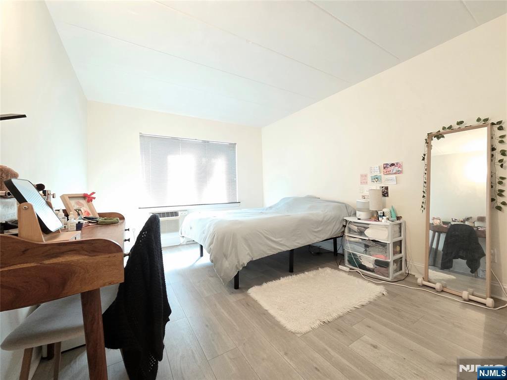 150 County Road, Unit 18 Tenafly, NJ 07670 - Photo 12 of 15 a bedroom with a bed and a chair