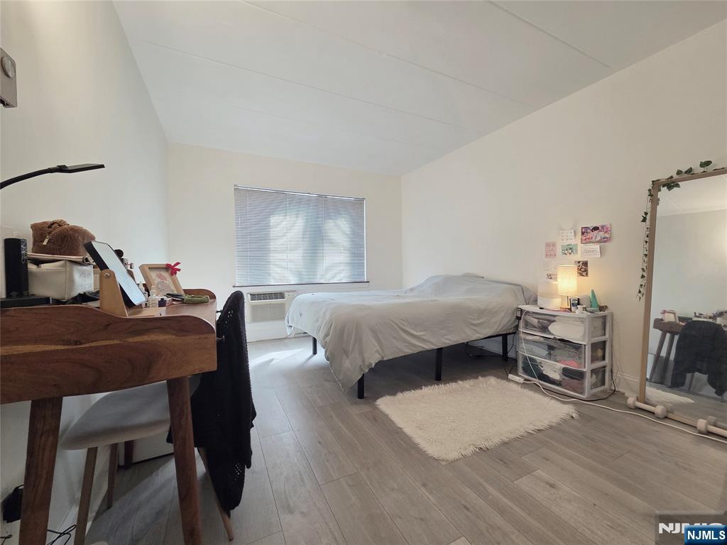 150 County Road, Unit 18 Tenafly, NJ 07670 - Photo 13 of 15 a bedroom with a bed and wooden floor