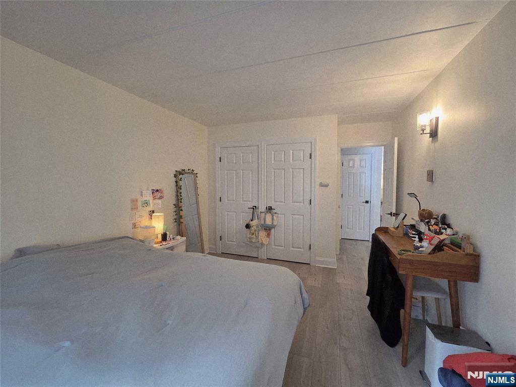 150 County Road, Unit 18 Tenafly, NJ 07670 - Photo 14 of 15 a bedroom with a bed and a couch