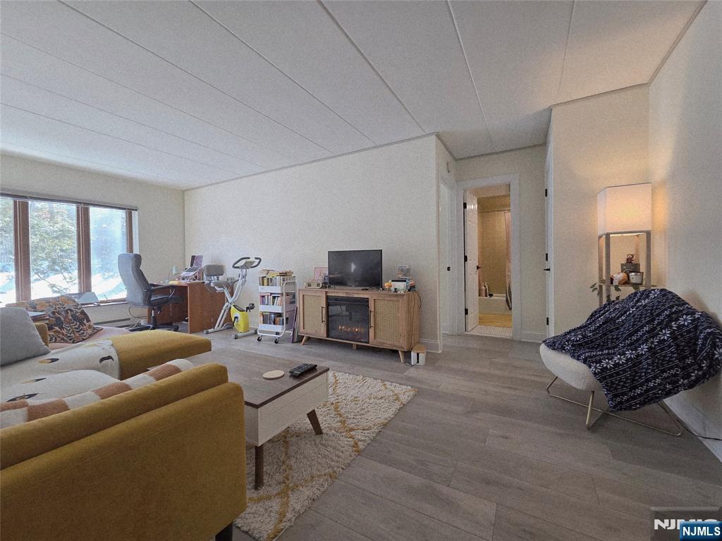 150 County Road, Unit 18 Tenafly, NJ 07670 - Photo 6 of 15 a living room with furniture and a fireplace