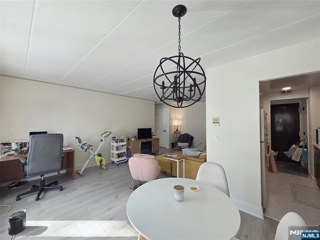 150 County Road, Unit 18 Tenafly, NJ 07670 - Photo 9 of 15 a view of a dining room with furniture wooden floor and chandelier