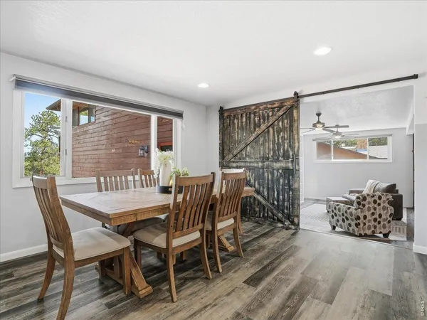 a view of a bedroom with furniture and wooden floor