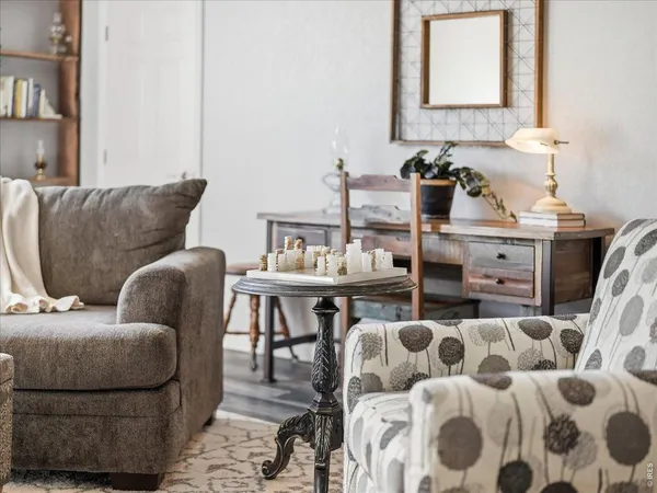a living room with furniture a flat screen tv and a fireplace