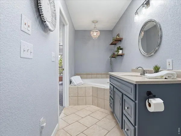 a bathroom with a sink a mirror and a shower