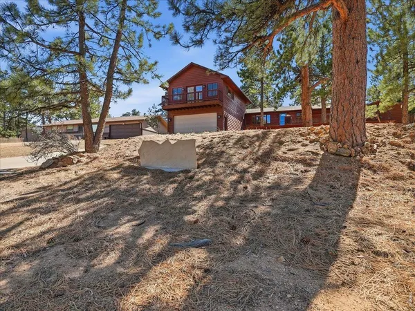 a view of a house with a yard covered in snow
