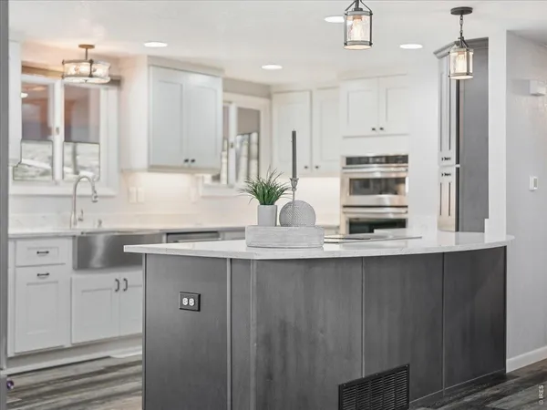 a view of kitchen with cabinets table and chairs