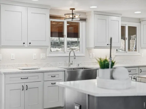 a kitchen with stainless steel appliances a sink stove and cabinets