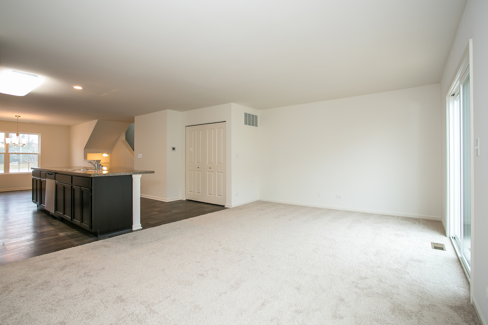 2364 Upland Road, Unit 2265 Pingree Grove, IL 60140 - Photo 4 of 18 a view of a big room with wooden floor and windows