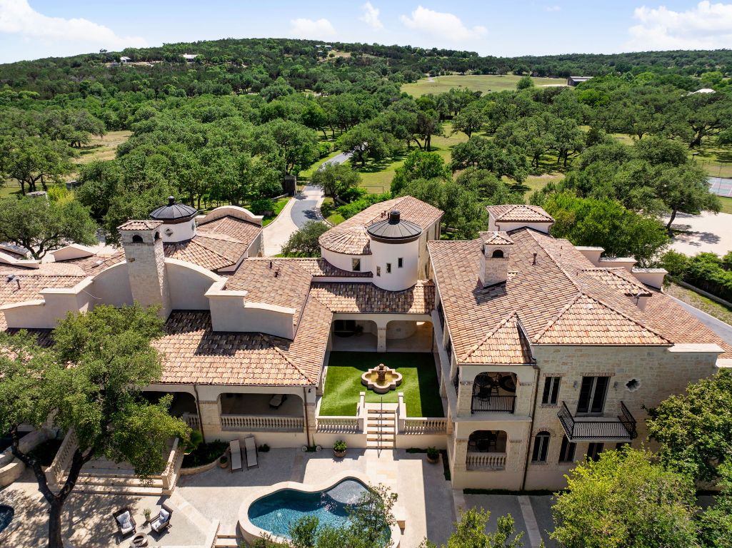an aerial view of a house with garden space and street view