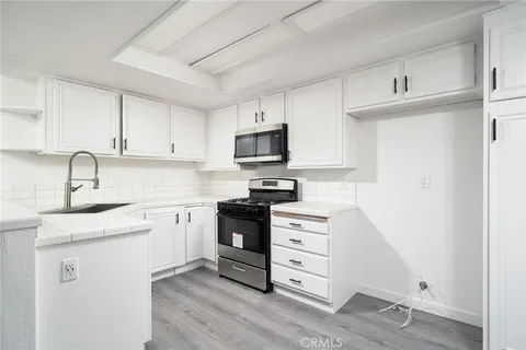 a kitchen with granite countertop a stove and a sink