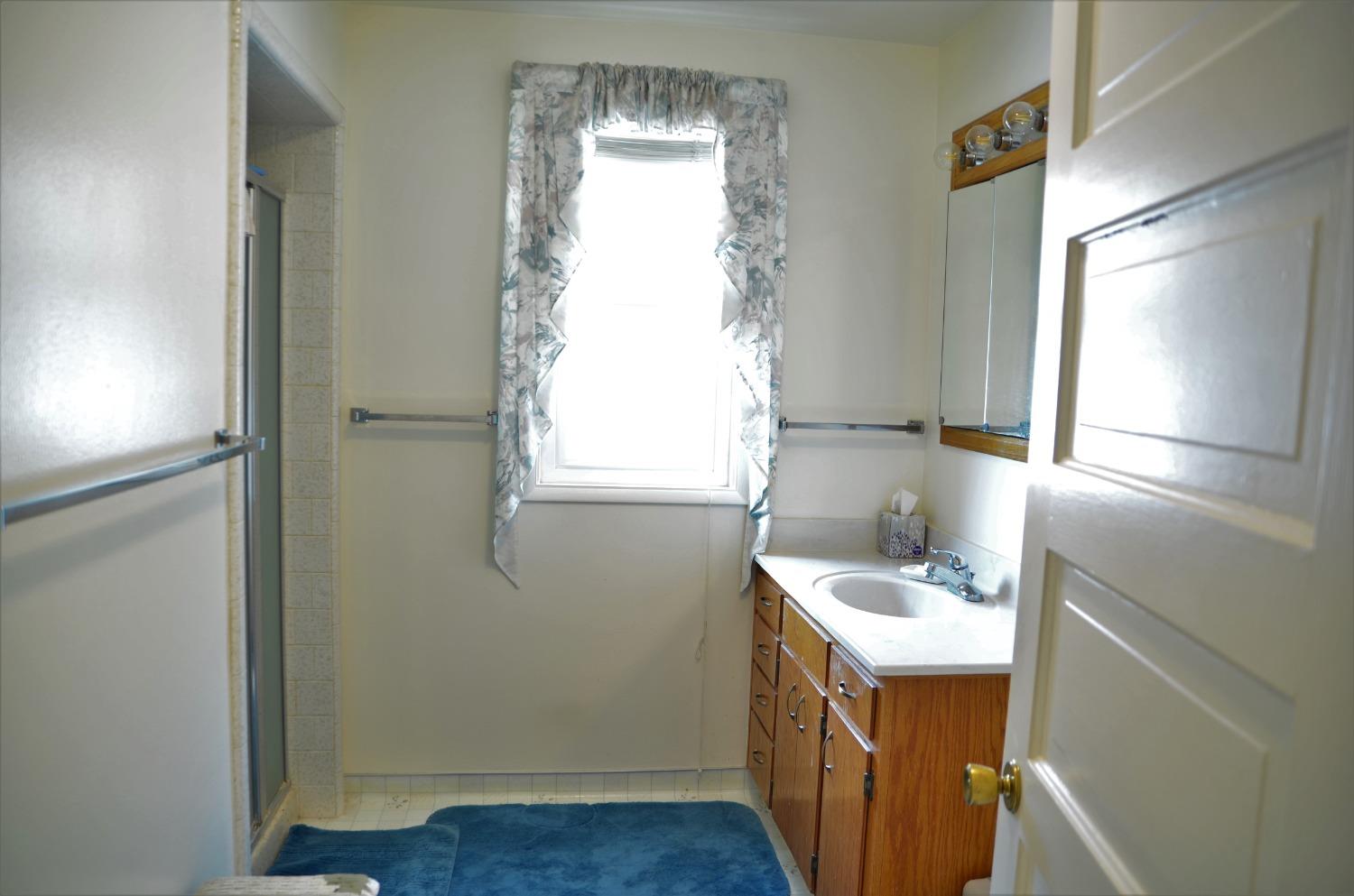 10888 Ave 412 Dinuba, CA 93618 - Photo 12 of 15 a bathroom with a sink a window and vanity