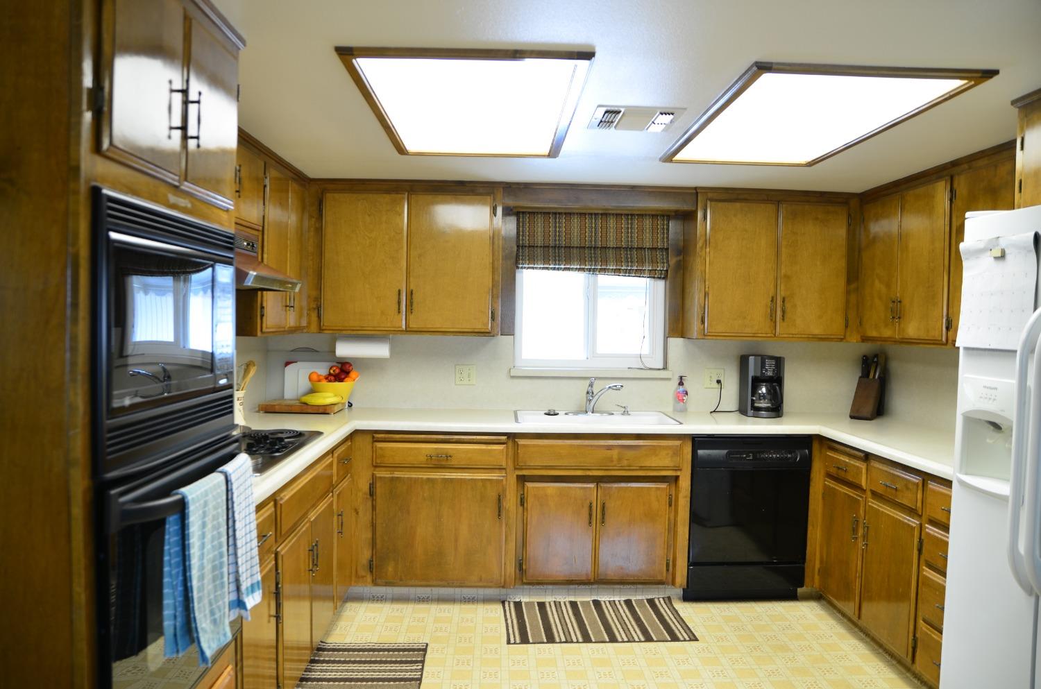 10888 Ave 412 Dinuba, CA 93618 - Photo 14 of 15 a kitchen with a sink a stove cabinets and a window
