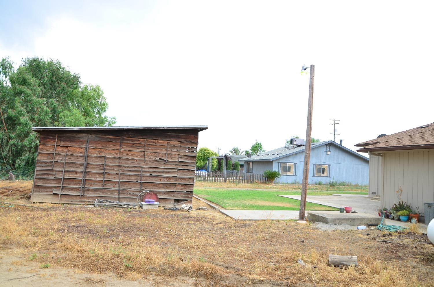 10888 Ave 412 Dinuba, CA 93618 - Photo 9 of 15 a view of a house with a backyard and a tree