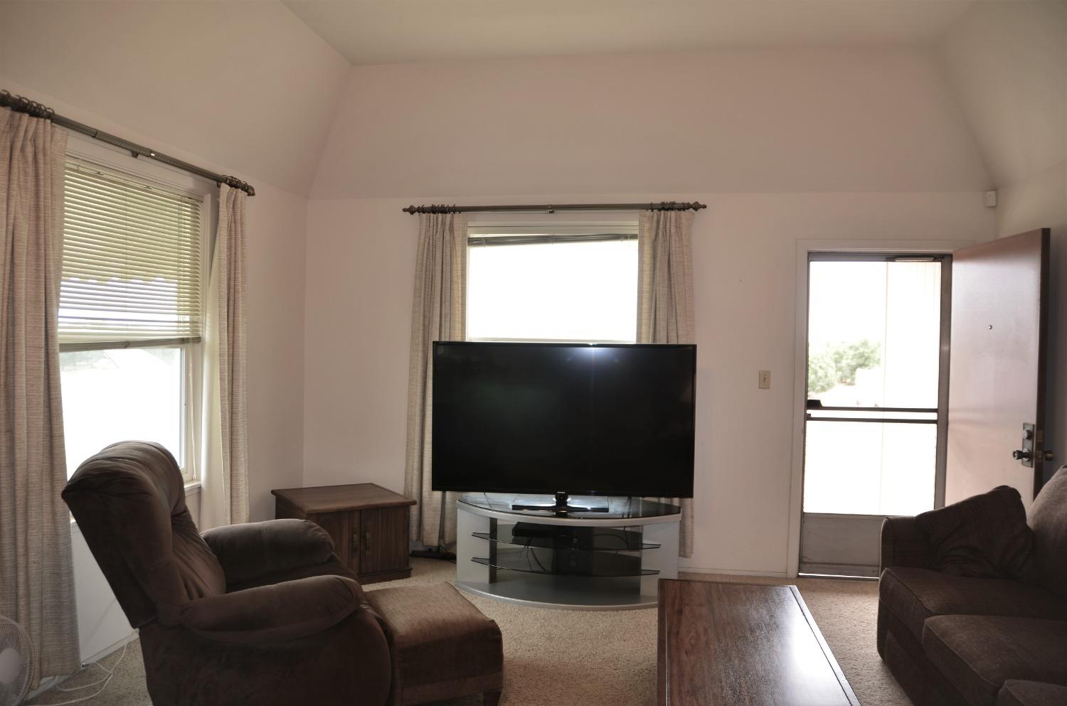 10888 Ave 412 Dinuba, CA 93618 - Photo 10 of 15 a living room with furniture and a flat screen tv