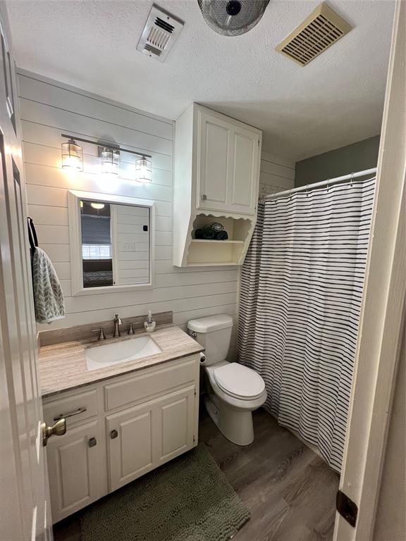 1337 South 11th Street Waco, TX 76706 - Photo 11 of 12 a bathroom with a toilet sink and mirror