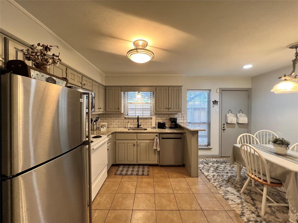 1337 South 11th Street Waco, TX 76706 - Photo 4 of 12 a kitchen with stainless steel appliances granite countertop a refrigerator and a sink
