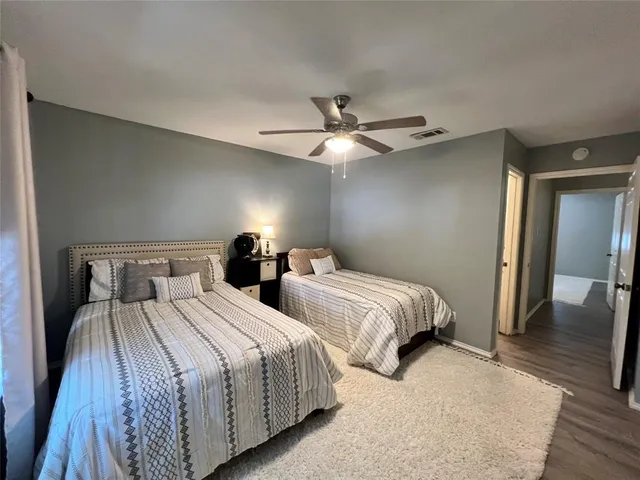 a bedroom with two beds and a chandelier