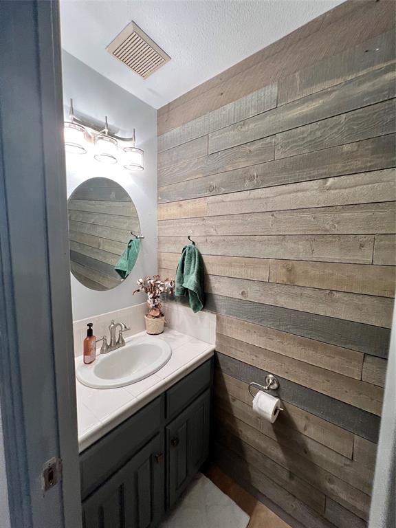 1337 South 11th Street Waco, TX 76706 - Photo 10 of 12 a bathroom with a sink and a mirror
