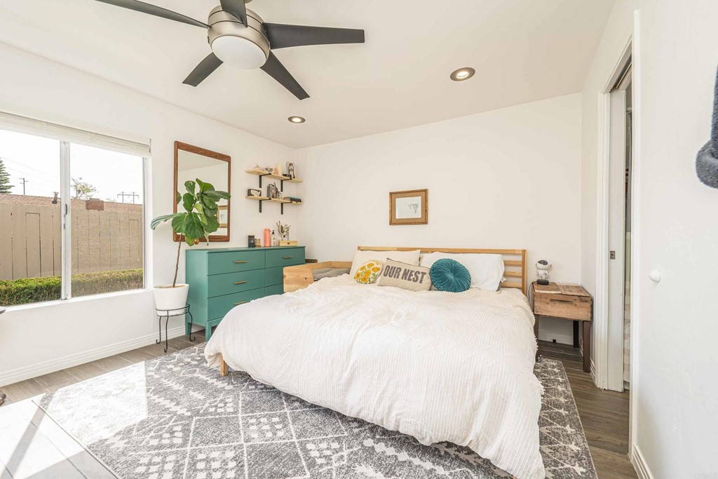 4159 Baycliff Way Oceanside, CA 92056 - Photo 13 of 23 a bedroom with a large bed and a chandelier fan