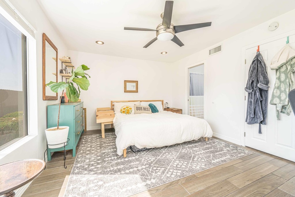 4159 Baycliff Way Oceanside, CA 92056 - Photo 14 of 23 a spacious bedroom with a bed a rug and a window