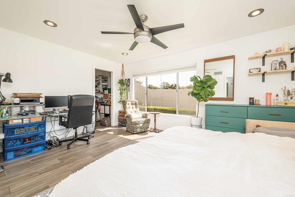 4159 Baycliff Way Oceanside, CA 92056 - Photo 16 of 23 a bedroom with a bed a large window and book shelf