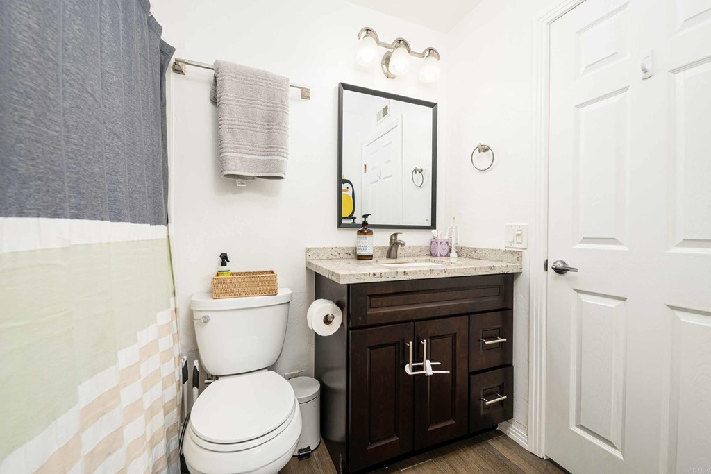 4159 Baycliff Way Oceanside, CA 92056 - Photo 17 of 23 a bathroom with a toilet a sink and mirror