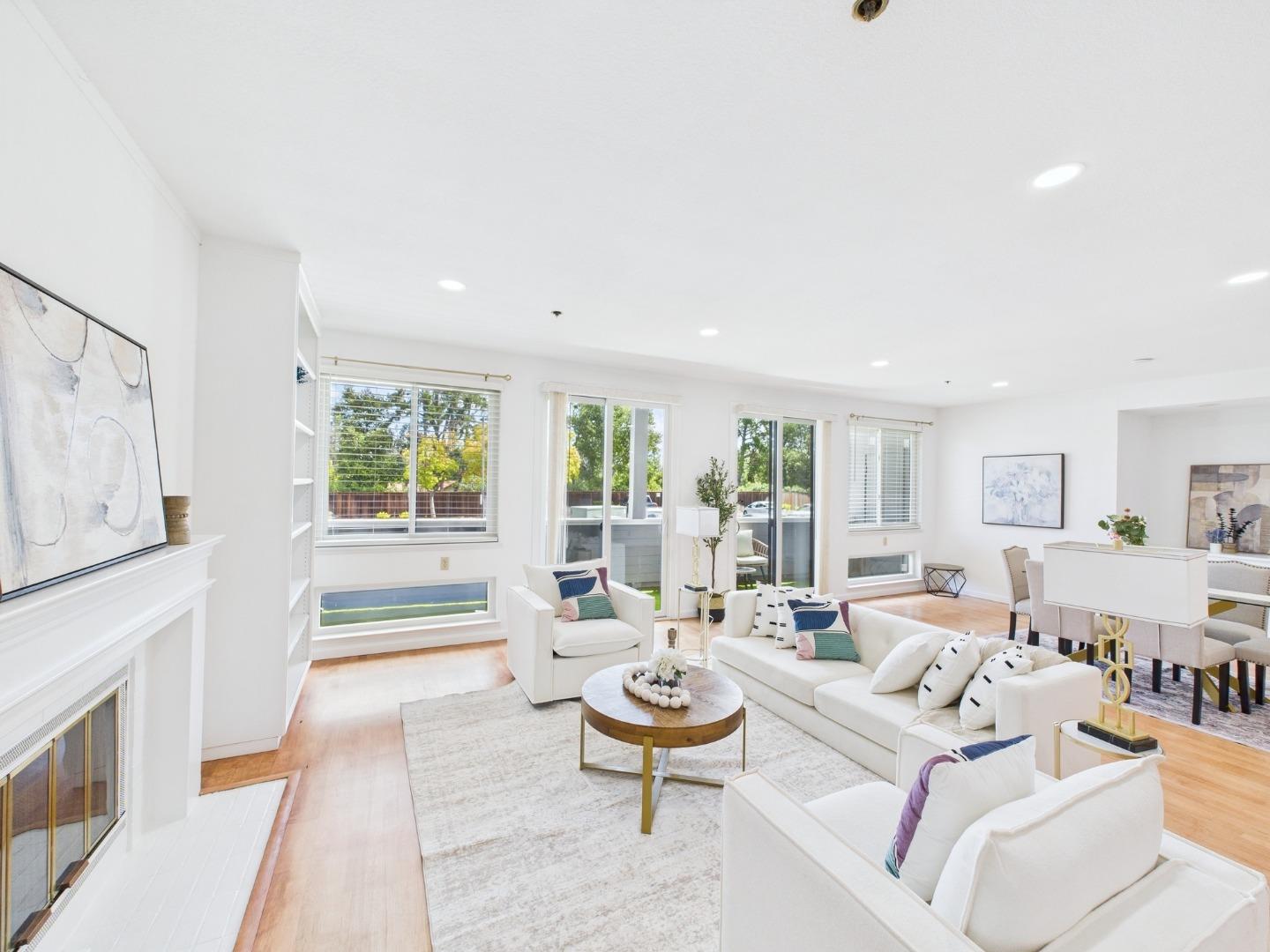 22330 Homestead Road, Unit 114 Cupertino, CA 95014 - Photo 1 of 1 a living room with fireplace furniture and a large window