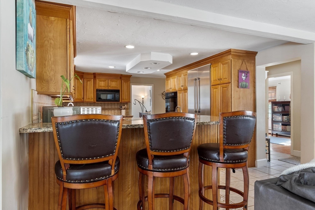 92 Prospect Street Lunenburg, MA 01462 - Photo 13 of 42 a living room with furniture a piano and a flat screen tv