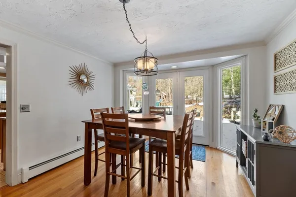 a view of a dining room with furniture window and wooden floor