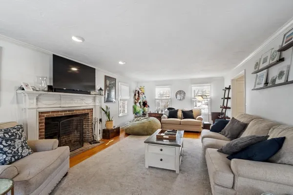 a living room with furniture a fireplace and a flat screen tv
